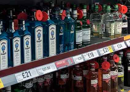 A super markets shelfs filled with differnet brands of gin
